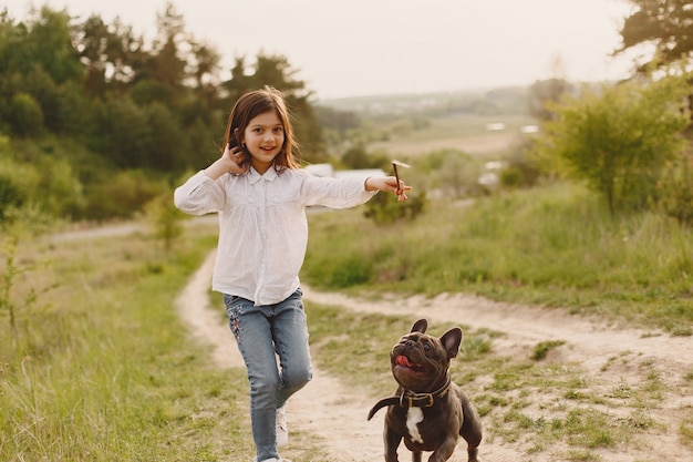 Child throwing stick, dog runs