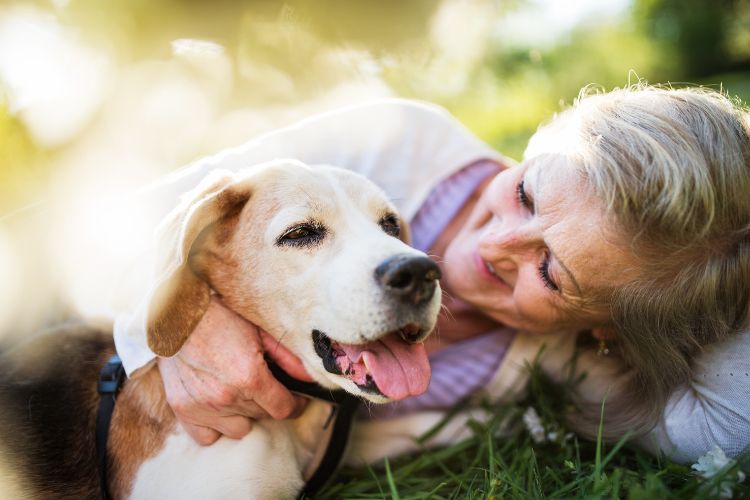 Woman snuggles with her dog